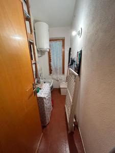 a hallway with a bathroom with a toilet and a door at Domo Austinu - Abbasanta in Abbasanta