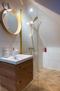 a bathroom with a sink and a mirror at Zacisze Arturówka in Laskowa