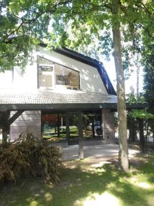 a house with a large window on the side of it at Kotwica Morska in Pobierowo