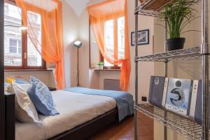 a bedroom with a bed and a tv in it at La Casa del Polpo Giallo by Wonderful Italy in Turin