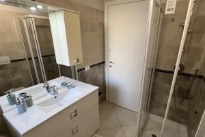 a bathroom with a sink and a shower at Plumosus in Arma di Taggia +5 photos