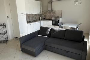 a living room with a couch and a kitchen at Plumosus in Arma di Taggia