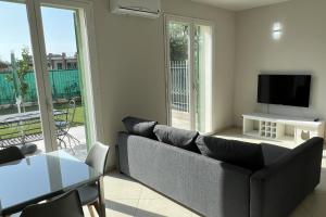 a living room with a couch and a tv at Plumosus in Arma di Taggia