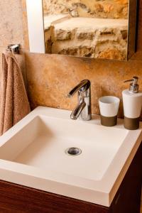 a white sink in a bathroom with a mirror at The Dream in Kastoria