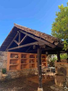 a building with shelves with a table in it at Finca Valdegrullas in Candeleda