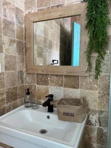 a bathroom with a sink with a mirror and a towel at Doğa içinde havuzlu villa in Aydın