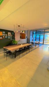 a large dining room with a large wooden table at Area Surf House in Muros