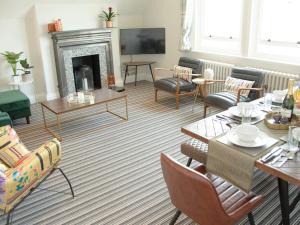 a living room filled with furniture and a fireplace at Pass the Keys Stylish apartment in stunning location plus parking in Bath