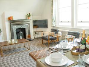 a living room with a table and a fireplace at Pass the Keys Stylish apartment in stunning location plus parking in Bath