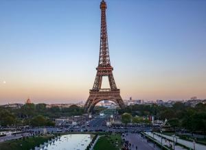 a view of the eiffel tower at sunset at Hotel Camelia in Boulogne-Billancourt