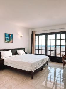 a bedroom with a large bed and a large window at Serenity Lodge in Sharm El Sheikh