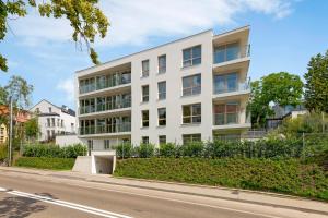 an apartment building on the side of a street at Willa Dattero Gdynia by Lion Apartments in Gdynia