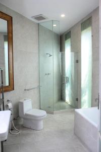 a bathroom with a shower and a toilet and a sink at Jade Waters 05 in Candi
