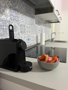 a kitchen counter with a microwave and a bowl of food at Casa Cirenaica Art House in Bologna