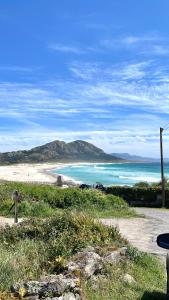 a view of a beach and the ocean at Area Surf House in Muros