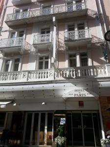 a large pink building with a hotel paris sign on it at Hôtel de Paris in Lourdes