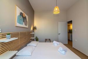 a bedroom with a large white bed with two pillows at Escape in Tinos in Tinos