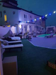 a building with a swimming pool at night at borgo vecchio *DREAM* in Lonato del Garda