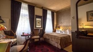 a hotel room with a bed and a desk and window at Myer's Hotel Berlin in Berlin +91 photos