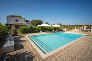 a large swimming pool in a yard with a house at TERRA TERRA - Masseria Minunni in Conversano