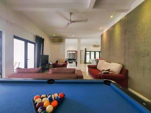 a living room with a pool table in the middle at Bungalow with Pool Karaoke PJ 12 in Petaling Jaya