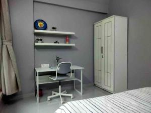 a bedroom with a desk and a chair and a cabinet at Angel Views 101, Chapel Road, Bandra West by Connekt Homes in Mumbai