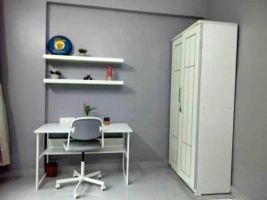 a white desk with a chair and a cabinet at Angel Views 101, Chapel Road, Bandra West by Connekt Homes in Mumbai