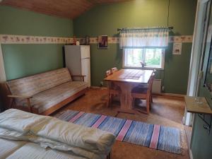 a living room with a table and a couch at Selholmens Camping in Älvsbyn