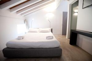 a bedroom with a large bed with white sheets and pillows at Casa Valentina in Mantova