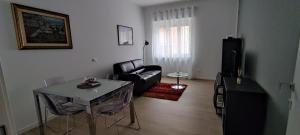 INTERNO NOVE - appartamento a Corsico في كورسيكو: غرفة معيشة مع أريكة وطاولة