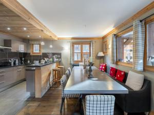 a kitchen with a long table in a room at Chalet cosy au centre de Courchevel Le Praz avec sauna, terrasse et parking - FR-1-568-15 in Courchevel