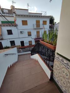 a balcony of a building with stairs and plants at El Cruce Hornos in Hornos