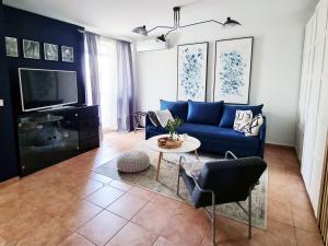 a living room with a blue couch and a table at Apartment Sol Dolcevita in Njivice
