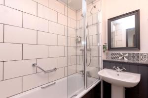 a bathroom with a shower and a sink and a mirror at The Harrogate Inn - The Inn Collection Group in Harrogate