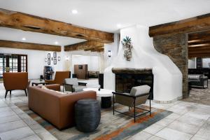 a living room with a couch and a fireplace at Courtyard by Marriott Albuquerque in Albuquerque