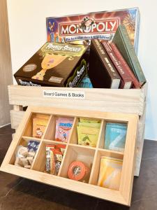 a wooden box filled with games and books at Ashiyana Escapes in Mount Tamborine