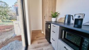 a kitchen with a counter top and a microwave at Ashiyana Escapes in Mount Tamborine