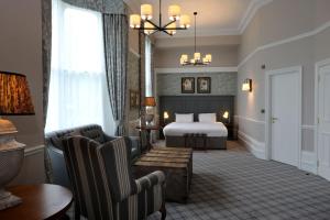 a hotel room with a bed and a table and chairs at The Harrogate Inn - The Inn Collection Group in Harrogate