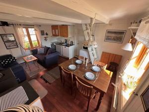 a living room with a dining table and a kitchen at Stamsund Harbour Apartment in Stamsund