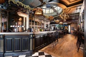 a bar in a restaurant with a ceiling at The Harrogate Inn - The Inn Collection Group in Harrogate