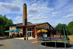 a building with a house with a play structure at Penzion U jezera in Konstantinovy Lázně