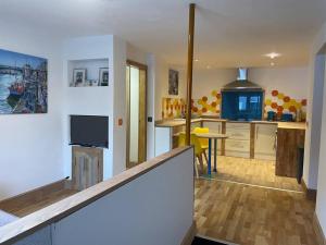 a room with a kitchen and a living room at Corner Post Holiday Letting in Weymouth