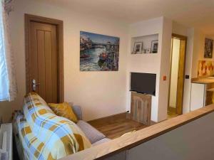 a living room with a couch and a flat screen tv at Corner Post Holiday Letting in Weymouth
