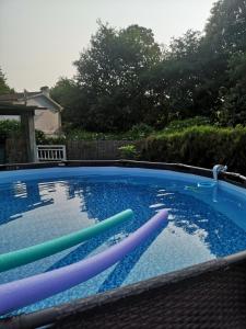 a swimming pool with colorful inflatables in it at Casa con piscina y jacuzzi in Pontevedra