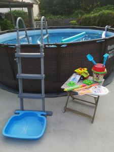 a chair and a ladder next to a swimming pool at Hospedaje Athena in Pontevedra