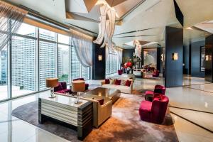 a living room with red chairs and a couch at The Kahala Hotel & Resort Yokohama in Yokohama