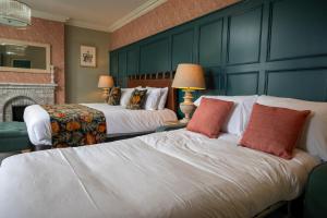 a hotel room with two beds and a fireplace at The Royal Inn by Chef & Brewer Collection in Bristol