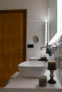 a bathroom with a large white tub on a counter at Hotel El Rosal de Cudillero in Cudillero