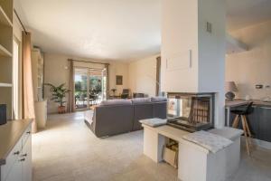 Una sala de estar con un sofá y una chimenea. en Villa Le Majole by Perle di Puglia, en Manduria