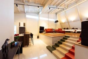 a living room with a staircase leading to a living room at MS STUDIO in Asahikawa